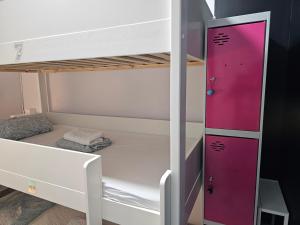 a white bunk bed with a pink door at Habitación Familiar in Madrid