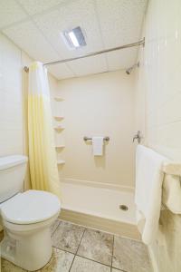 a bathroom with a white toilet and a shower at Town & Country Inn & Resort in Gorham