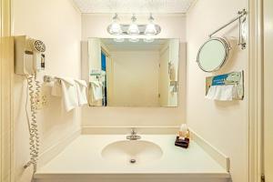 a bathroom with a sink and a mirror at Town & Country Inn & Resort in Gorham