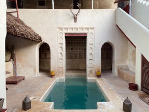 a swimming pool in a courtyard of a building at Umma House in Lamu