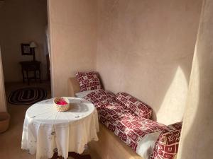 a living room with a table and two couches at Umma House in Lamu +18 photos