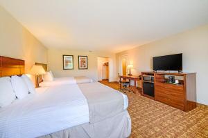 a hotel room with two beds and a flat screen tv at Town & Country Inn & Resort in Gorham