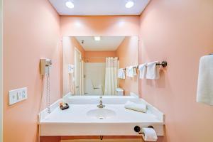 a bathroom with a sink and a large mirror at Town & Country Inn & Resort in Gorham