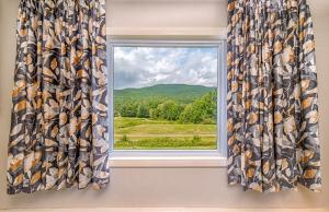 a window with a view of a mountain at Town & Country Inn & Resort in Gorham
