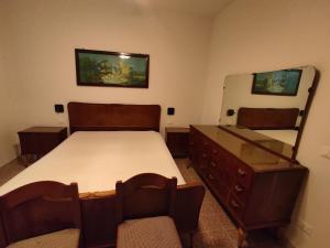 a bedroom with a bed and a dresser and a mirror at Lunamora 2 in Rodi Garganico