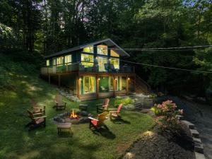 a house with a fire pit in the yard at Belleau Lake Escape in Wakefield