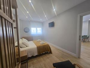 a bedroom with a bed in a room with lights at Lugo Apartamento nuevo en centro de la ciudad in Lugo