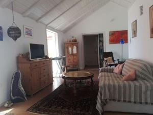 a living room with a couch and a table at Ferienhaus Finca Sonrisa in Puntagorda