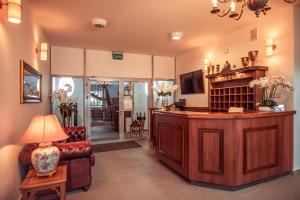 a living room with a couch and a table at Hotel Maxim Kwidzyn in Kwidzyn