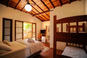 Ένα ή περισσότερα κρεβάτια σε δωμάτιο στο Pousada Paradise Ferrugem