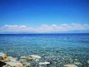 a large body of water with rocks in it at Dimos Apartments in Likoporiá