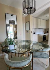 a dining room with a glass table and chairs at LIZA I Sea View in Lokva Rogoznica