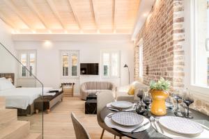 a living room with a dining table and a bedroom at Murofinto Homes De Vecchio in Corfu