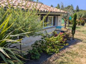 a small house with a bunch of plants in front of it at Gite charme et campagne in Montazeau