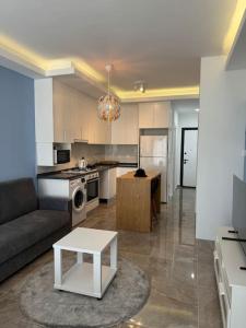 a living room with a couch and a table at Schönes Apartment mit Luxus-Design auf Nordzypern, in Caesar Resort Marcellus 52 in İskele +50 photos
