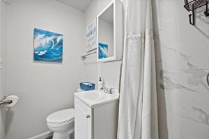 a white bathroom with a sink and a toilet at Central Location Studio Walk to Times Square in New York +7 photos