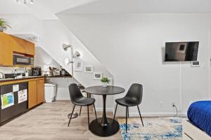 a small kitchen with a table and chairs in a room at Central Location Studio Walk to Times Square in New York