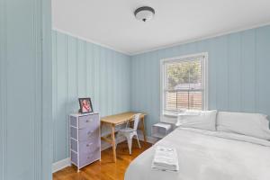 a bedroom with a bed and a desk and a table at Charming 3-bedroom house in Wilmington with WiFi, AC in Wilmington