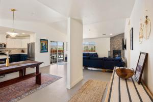 a kitchen and living room with a table and a dining room at Bonanza in the Desert - Pool, Hot Tub, Grill home in Yucca Valley +11 photos