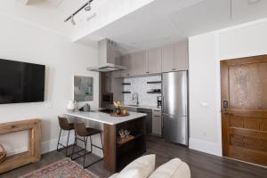a kitchen with a table and a refrigerator at Southern Exposure at The Brent Lofts in Pensacola