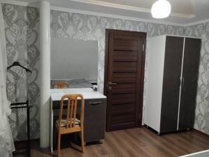 a small kitchen with a counter and a refrigerator at White cute house in Karakol