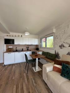 een keuken en woonkamer met een bank en een tafel bij Chalet 4 pers confort 100mdespistes St Lary 4 étoiles in Saint-Lary-Soulan +29 foto's