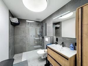 a bathroom with a sink and a toilet and a shower at Residence pascalino in Ans +15 photos