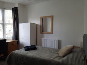 a bedroom with a bed and a mirror on the wall at Portsmouth House near Centre 3 Bedrooms in Portsmouth