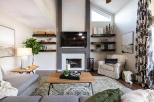 a living room with a couch and a fireplace at Gilbert Comstock in Gilbert
