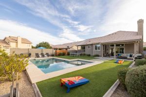 a backyard with a swimming pool and a house at Gilbert Comstock in Gilbert