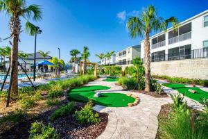 a golf course at the resort with palm trees at Stunning Home wPrivate Pool, minutes from Disney in Davenport