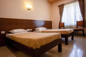 Postel nebo postele na pokoji v ubytování Philomena Hotel & Apartment