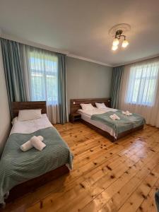 Postel nebo postele na pokoji v ubytování Polaris Kazbegi