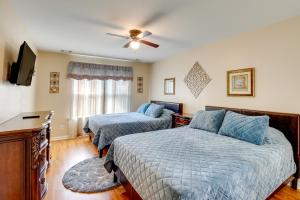 a bedroom with two beds and a flat screen tv at Screened Patio Rincon Home, 18 Mi to Savannah! in Rincon