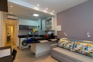 a kitchen and living room with a couch and a stove at Apto Copacabana 200 da Praia - Suíte + Lava&Seca in Rio de Janeiro