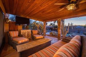 a living room with a couch and chairs and a television at North Scottsdale on 70th in Carefree