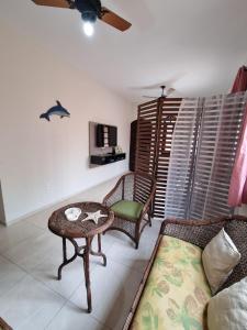 a living room with a couch and a table at Casa com piscina in Bertioga