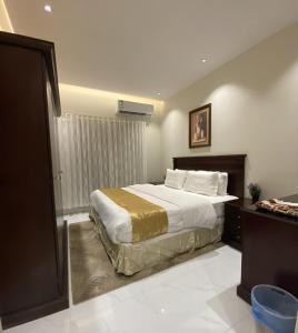 リヤドにあるالملز- شقق فاخرة Vip Apartments - Al Malazのベッドと窓のあるホテルの部屋