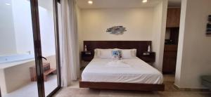 a bedroom with a bed and a tub in a room at Itzamná Suite Deluxe con Jacuzzi in Playa del Carmen +32 photos