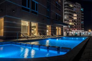 a large swimming pool in a building at night at Hotel Diego de Almagro La Serena in La Serena