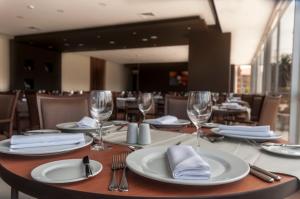 a table with glasses and plates and napkins on it at Hotel Diego de Almagro La Serena in La Serena +29 photos