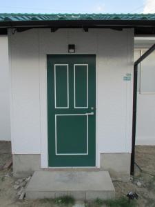 a green door on a white house with a porch at Fukuoka - House / Vacation STAY 4644 in Fukuoka