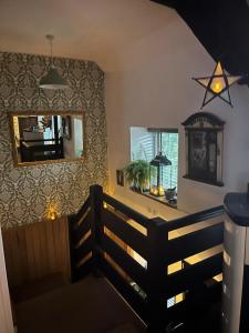 a dining room with a mirror and a table at Harlequin Cottage in Llangernyw