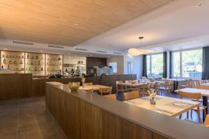 a restaurant with tables and chairs and a bar at Hotel Seehof Laax in Laax +57 photos