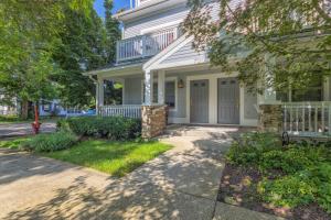 a white house with a porch and a balcony at Butler Street Condo #16 - Walking Distance to downtown Saugatuck - Newer vacation rental in Saugatuck