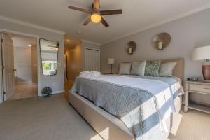 a bedroom with a bed and a ceiling fan at Butler Street Condo #16 - Walking Distance to downtown Saugatuck - Newer vacation rental in Saugatuck