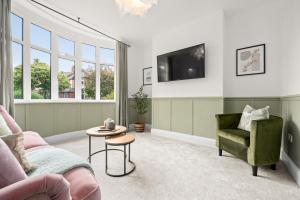 a living room with a couch and a chair and a tv at Stunning 3 Bedroom Home in Northwich in Northwich