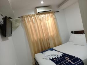 Postel nebo postele na pokoji v ubytování Hotel La Leyenda Vallenata