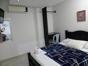Postel nebo postele na pokoji v ubytování Hotel La Leyenda Vallenata