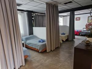 a hospital room with two beds and curtains at Chill 12 Guest House in Playa Blanca
